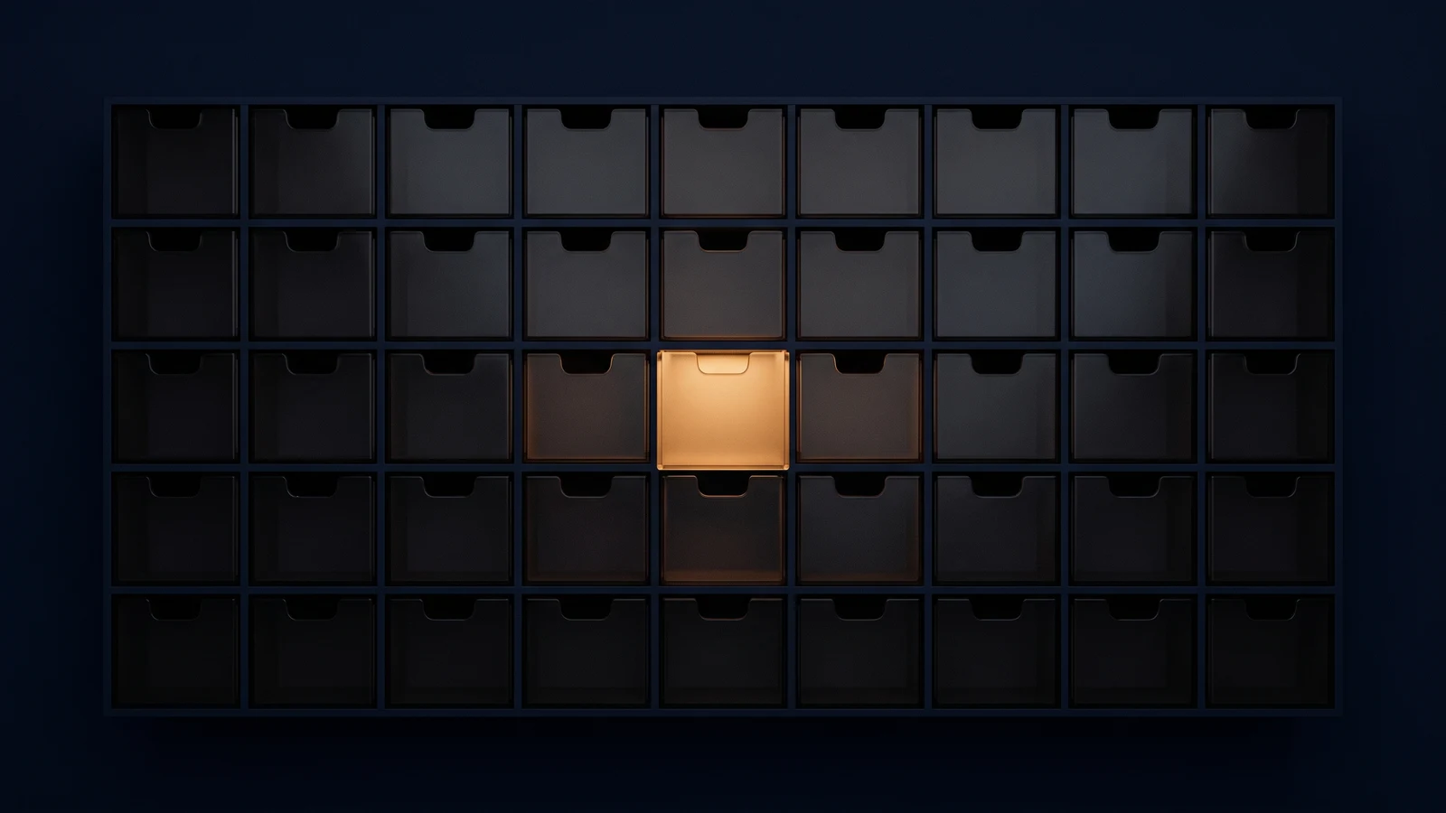 A broad wall of many identical small blank drawer fronts of dark smoked glass in a deep blue void, all dark, with one drawer near the center pulled well proud and the empty channel behind it washed warm amber