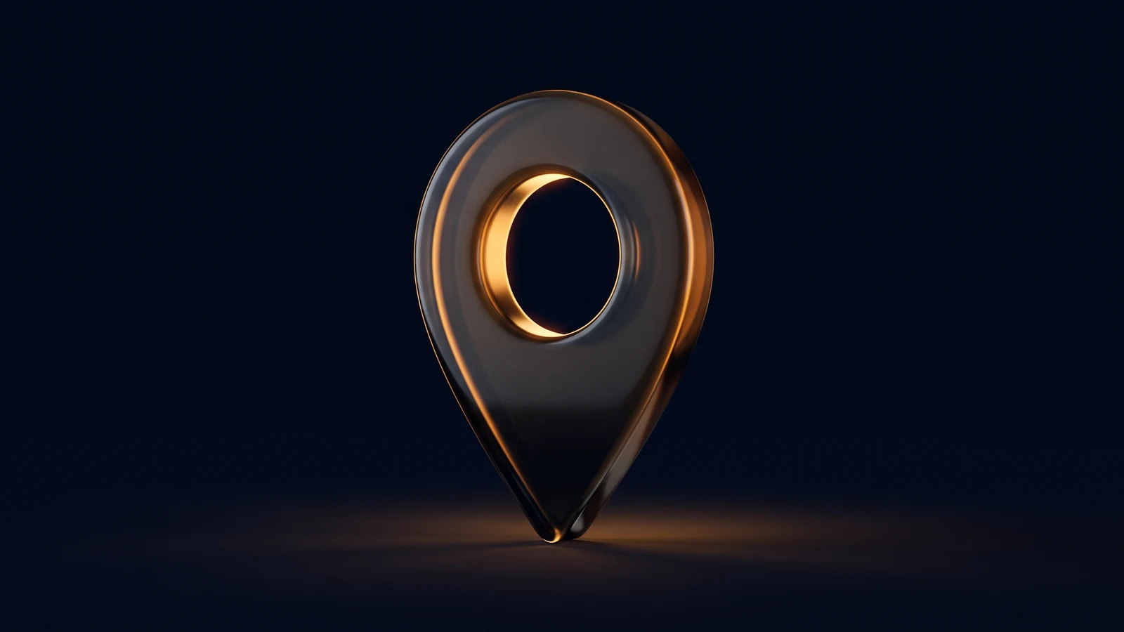 A single map location pin of dark smoked glass standing upright in a deep blue void, warm amber light glowing from inside its round opening and pooling on the floor beneath