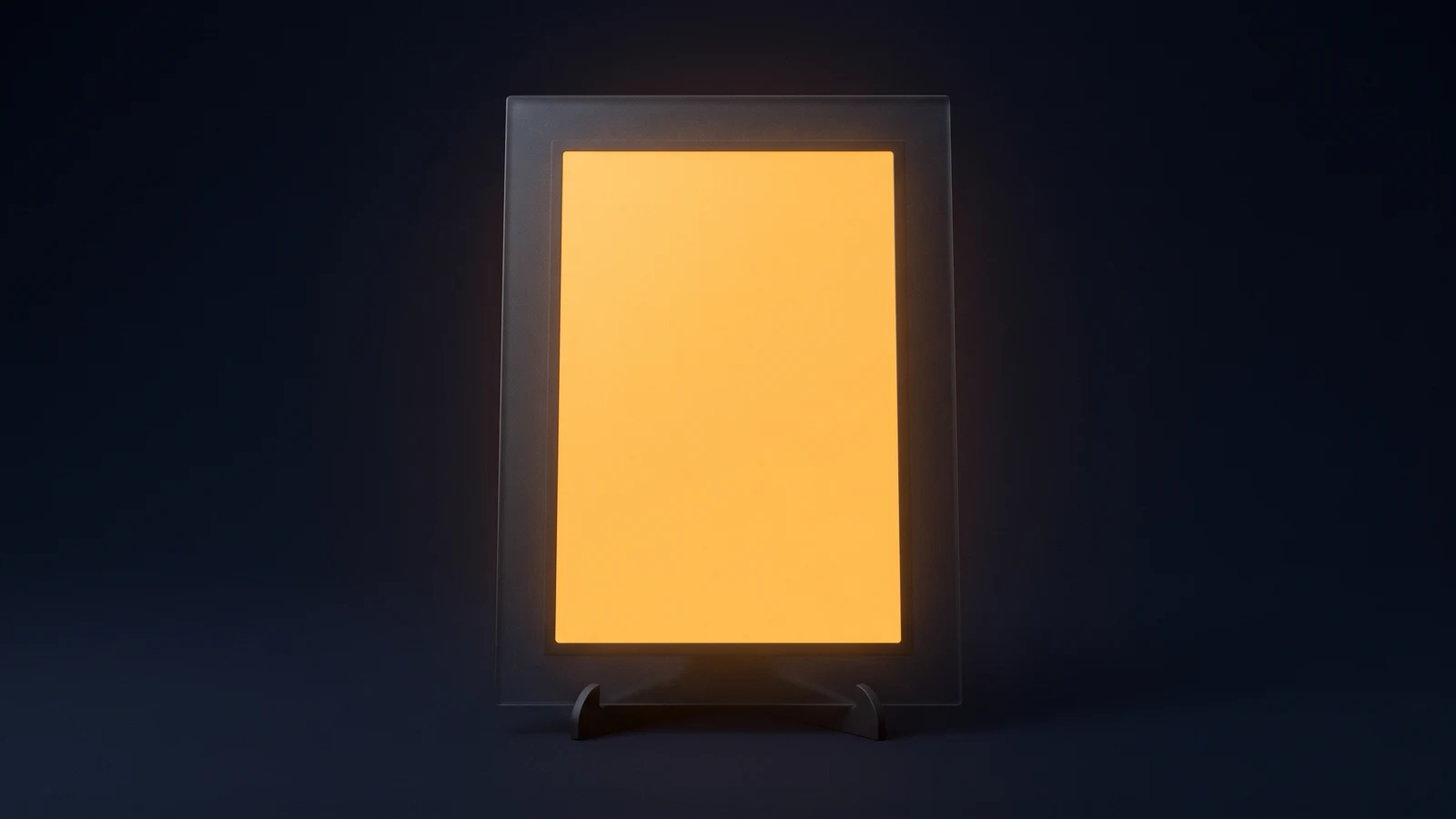 An upright digital photo frame of matte near-black glass on a small easel foot in a deep blue void, its screen a completely blank panel glowing warm amber