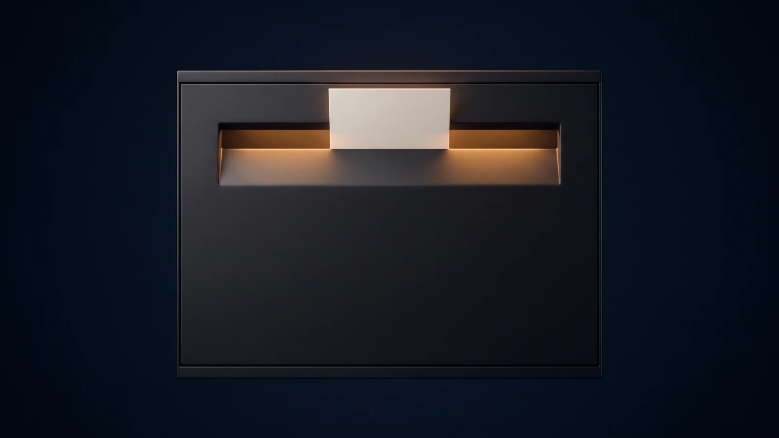A broad wall-mounted mail drop box of matte near-black charcoal seen dead-on in a deep blue void, its face completely blank, one wide horizontal posting slot lit warm amber from inside the box, and a single completely blank card standing half inserted in the slot