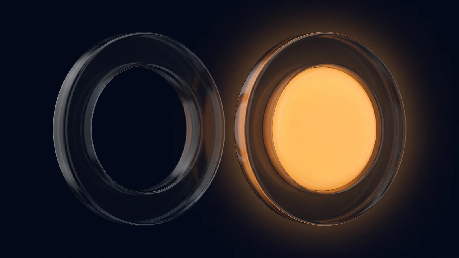 Two large radio-button rings of dark smoked glass side by side in a deep blue void, the left one hollow and dark, the right one holding a round core glowing warm amber