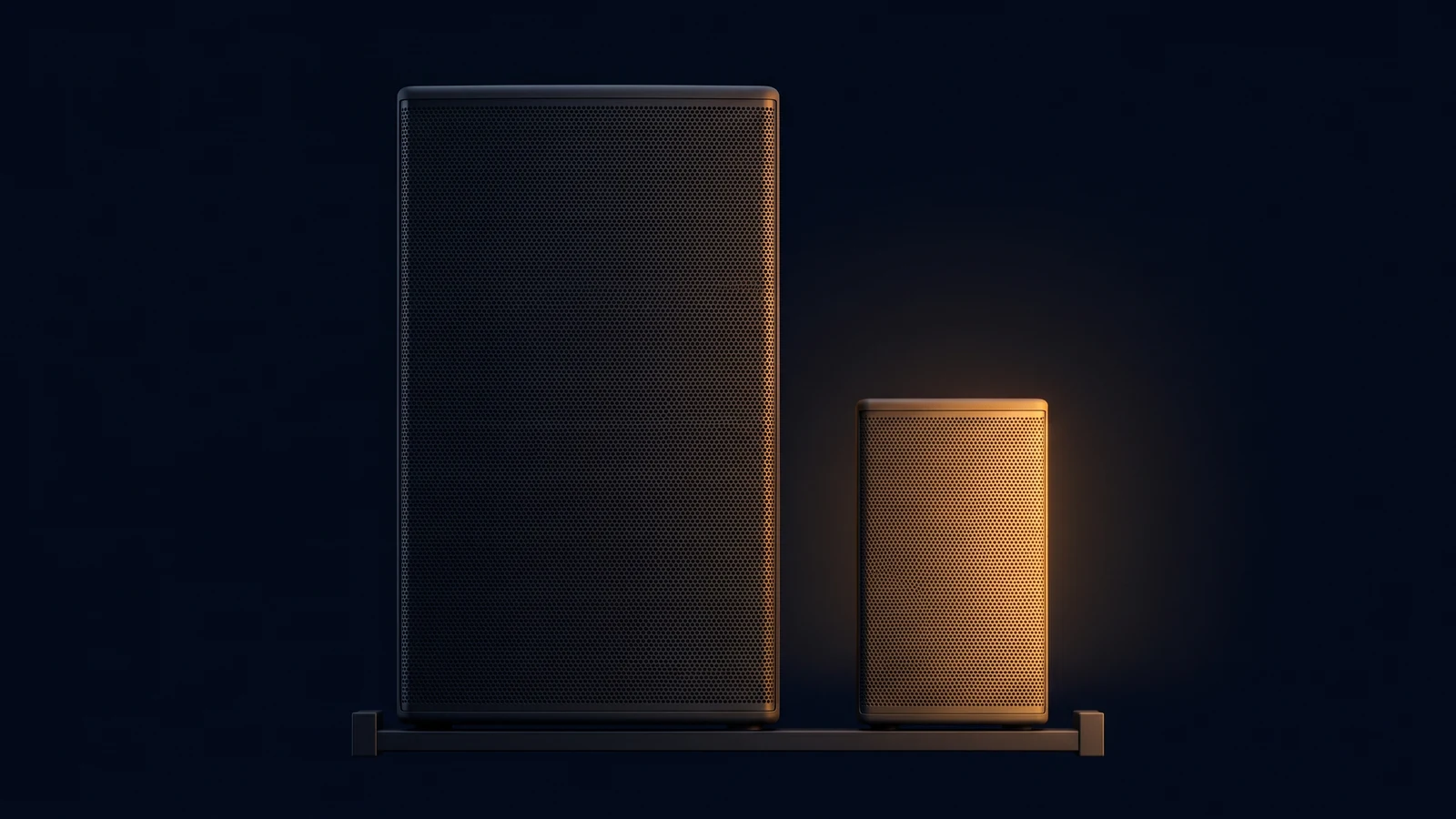 Two blank loudspeaker cabinets of very different size standing side by side on a low base rail in a deep blue void, the large one on the left left entirely dark and the small one on the right washed warm amber from within