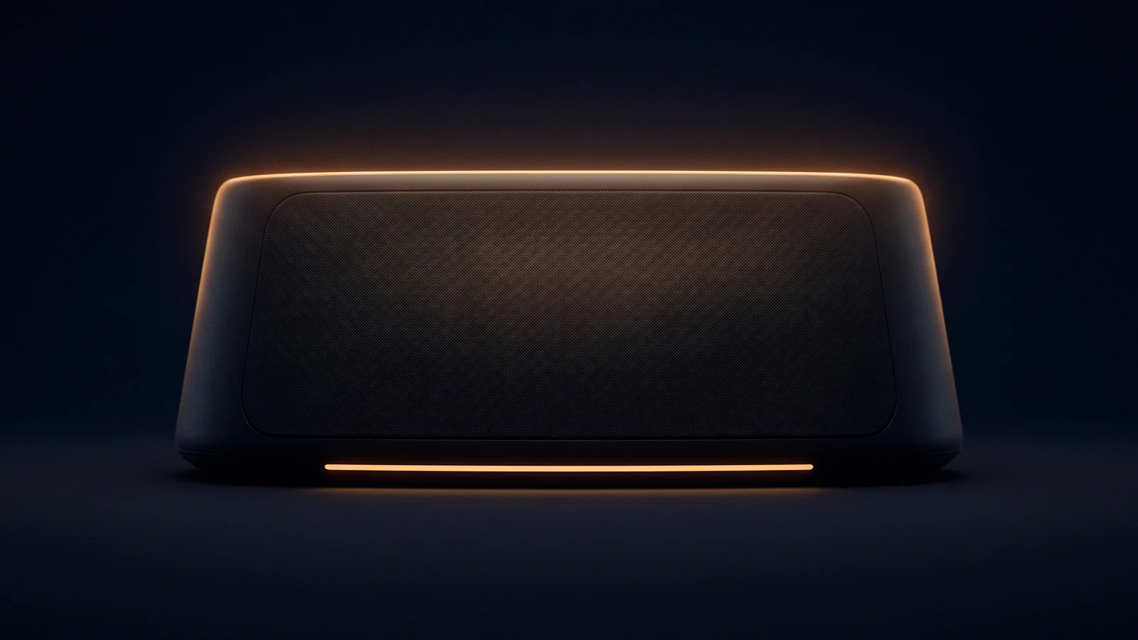 A broad low dark desktop voice terminal resting face-on in a deep blue void, its whole front a blank unmarked panel traced by a warm rim along the top, with one narrow horizontal band across its base glowing warm amber