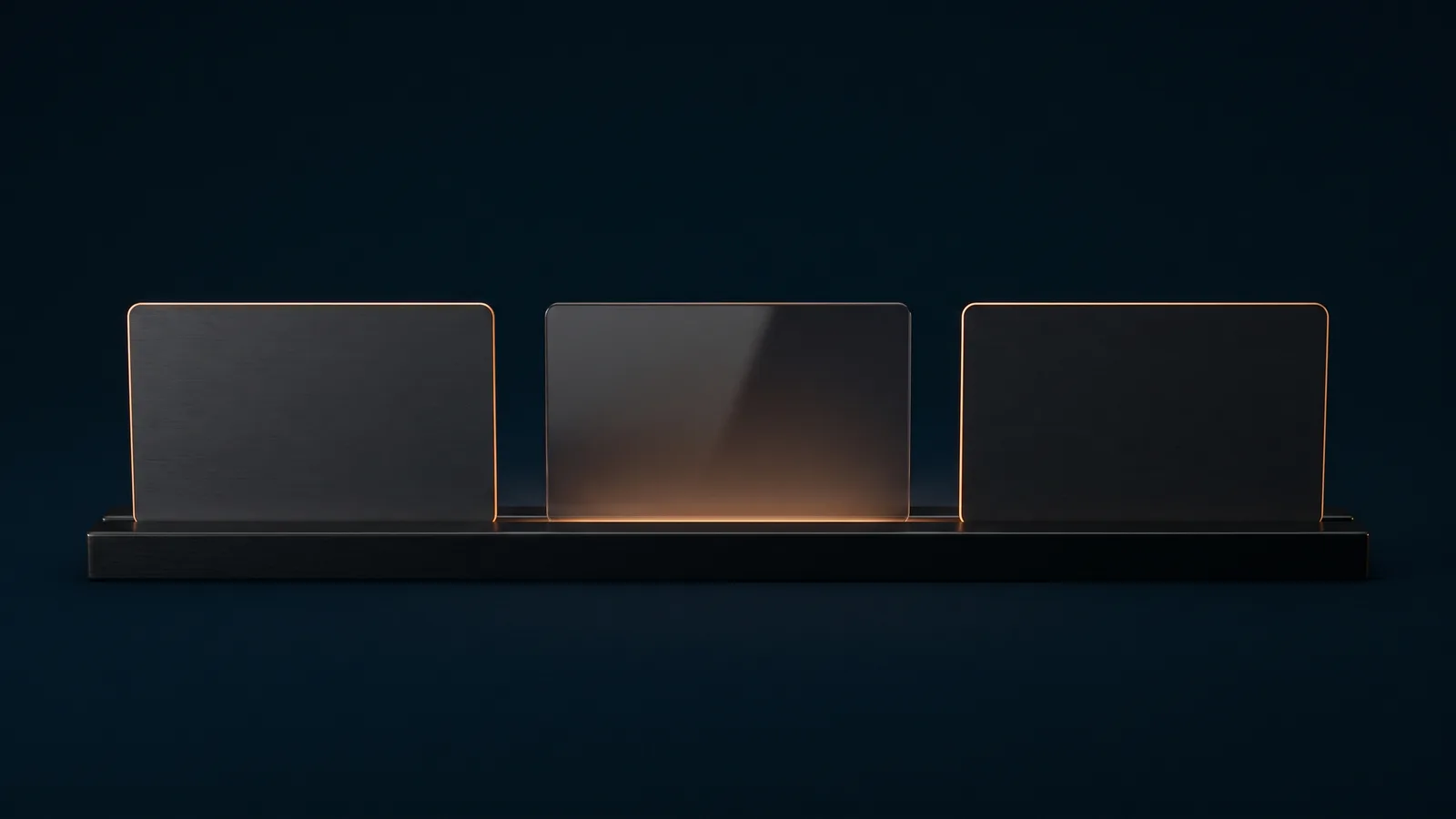 Three small blank landscape cards standing upright in a row on a long dark base rail in a deep blue void, the two outer cards dark and traced by a thin warm amber rim, the middle card glowing softly warm amber from beneath